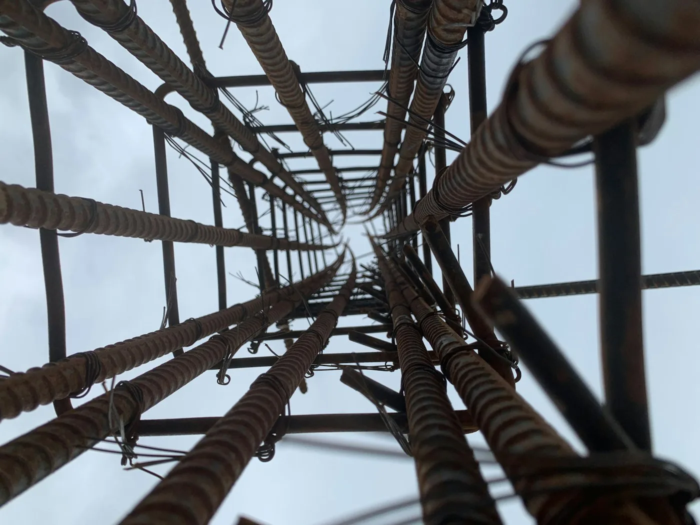Structural steel and concrete meeting with precision — accuracy in the frame is what makes flawless finishes possible