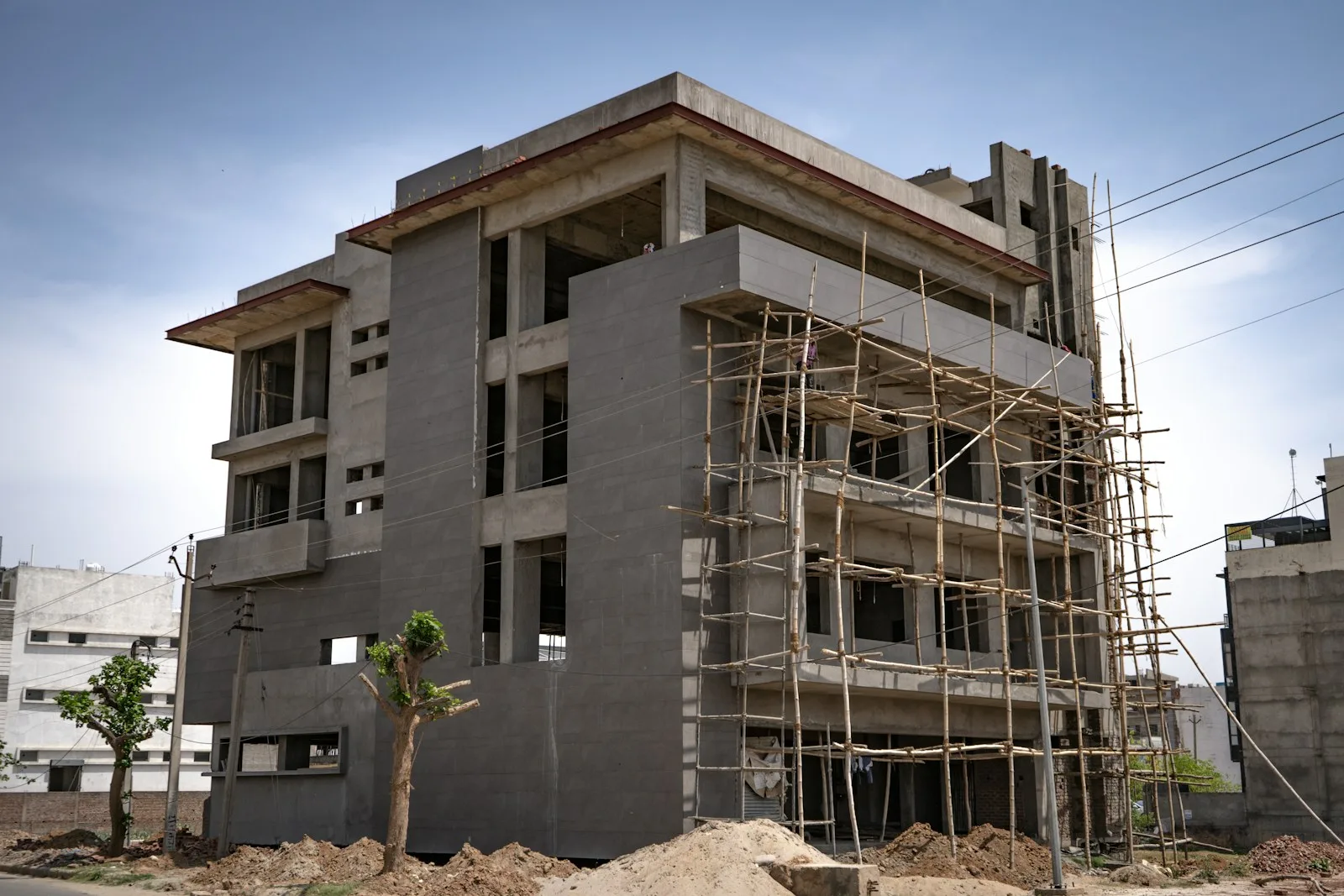 Months 2–6: the reinforced concrete structure rises level by level, each one inspected and approved before the next begins
